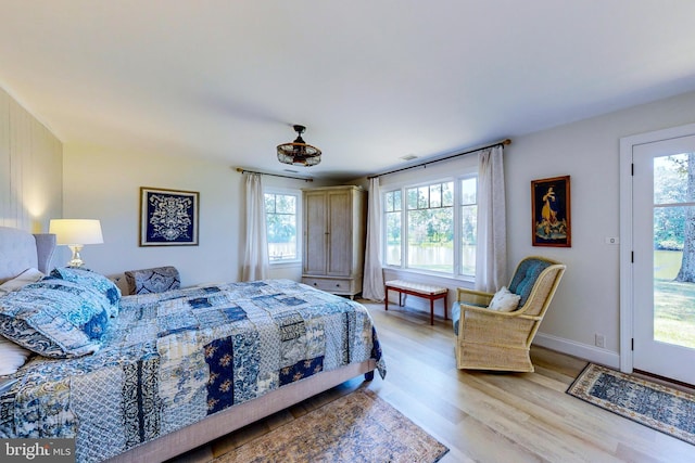 bedroom featuring visible vents, light wood-style flooring, and baseboards