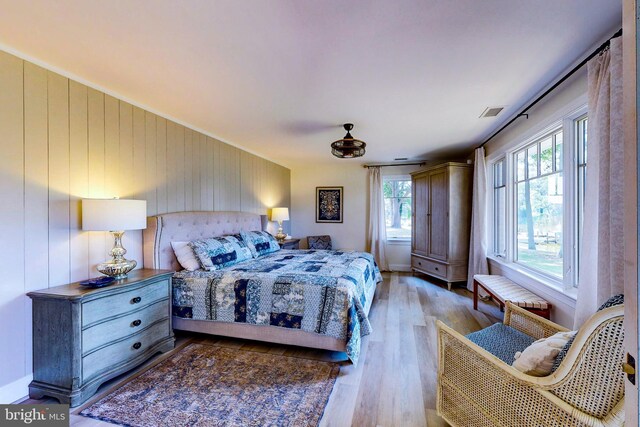 bedroom featuring visible vents and wood finished floors