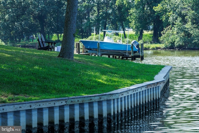 view of dock featuring a yard, a water view, and boat lift