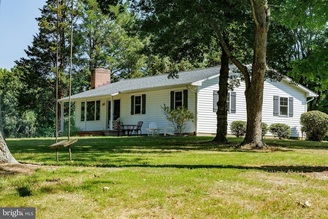 ranch-style house featuring a front yard and a chimney