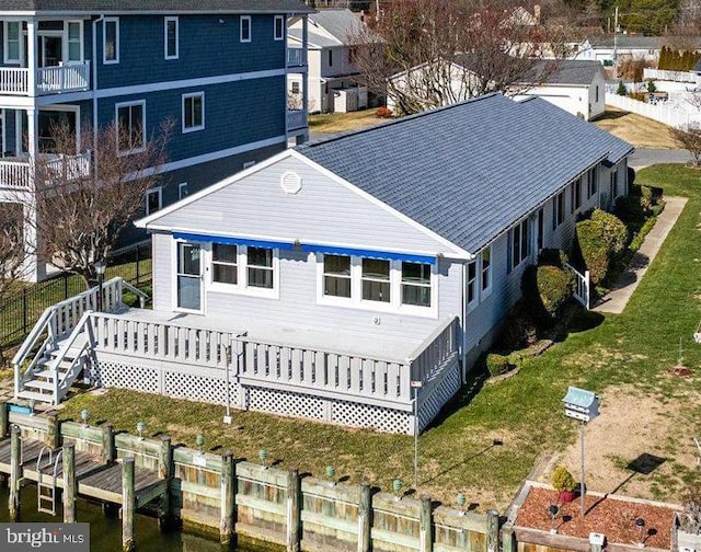 rear view of property with a lawn