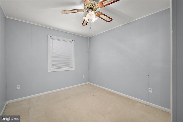 empty room featuring ornamental molding, carpet flooring, baseboards, and ceiling fan