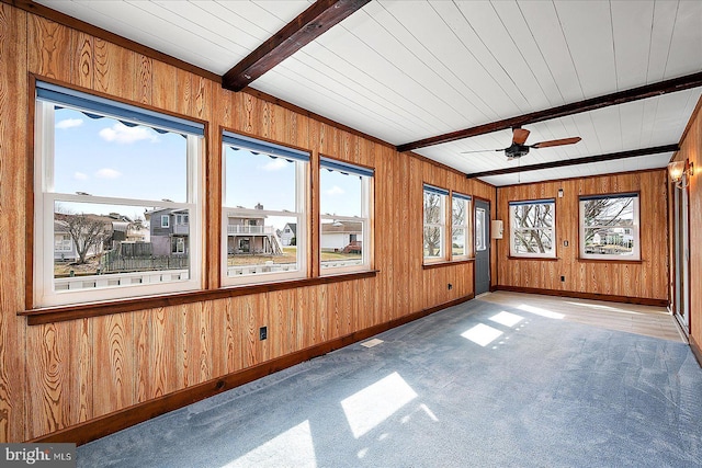 unfurnished sunroom featuring beam ceiling