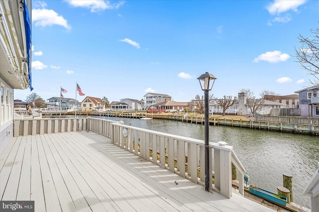 deck with a residential view and a water view