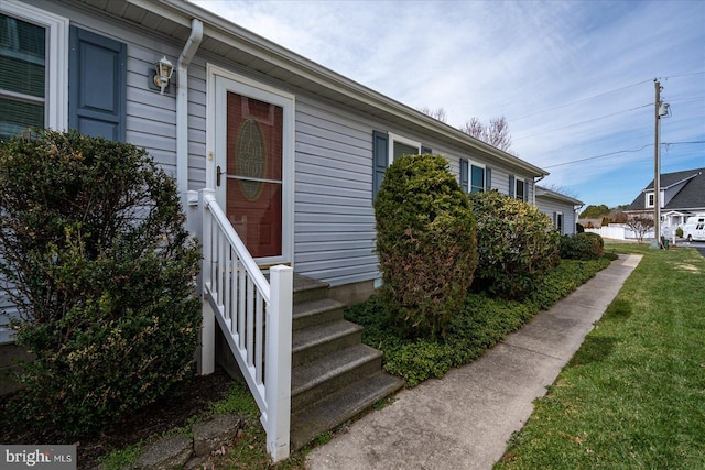 entrance to property with a yard