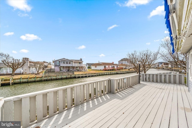 deck featuring a residential view and a water view