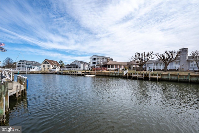 view of dock featuring a residential view and a water view