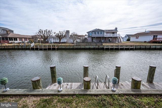 dock area featuring a residential view and a water view