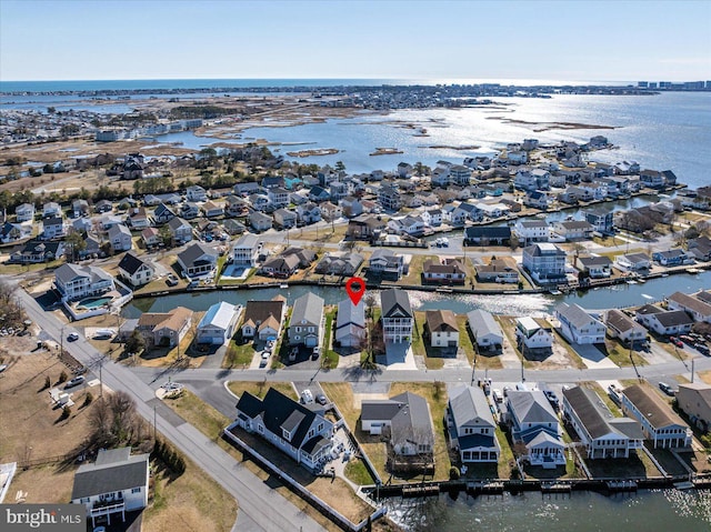 birds eye view of property with a water view and a residential view