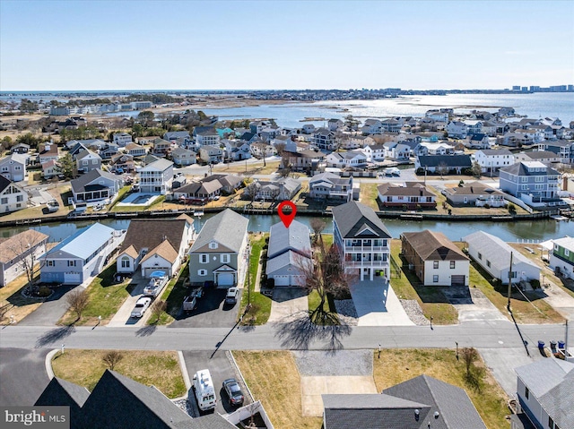 drone / aerial view with a residential view and a water view