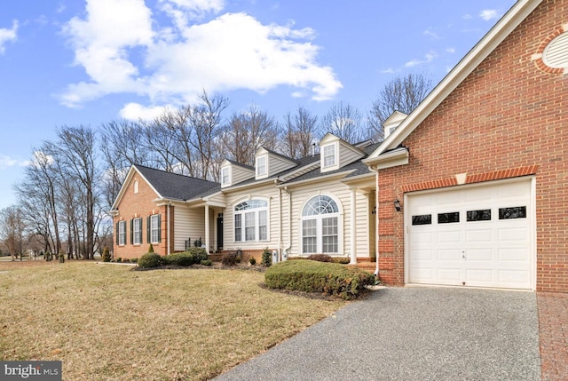 view of front of property featuring aphalt driveway, brick siding, a garage, and a front lawn