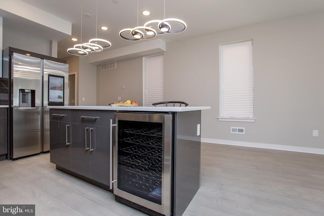 kitchen with stainless steel fridge, visible vents, wine cooler, modern cabinets, and light wood-type flooring