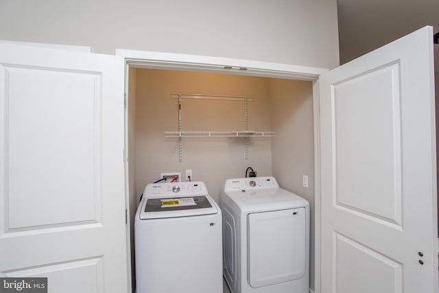 washroom featuring laundry area and washer and dryer