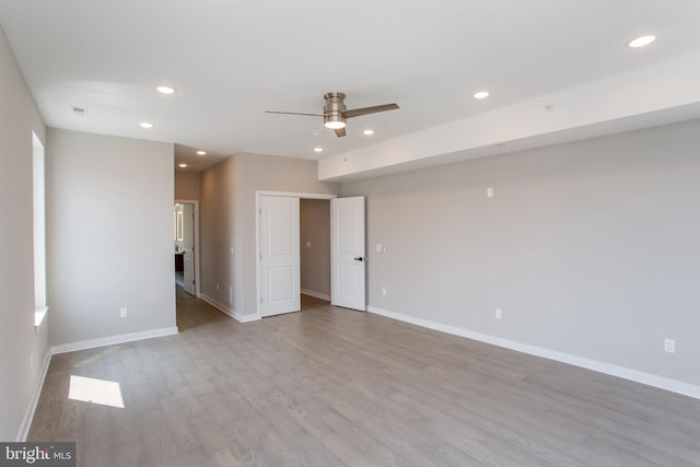 spare room featuring baseboards, ceiling fan, wood finished floors, and recessed lighting