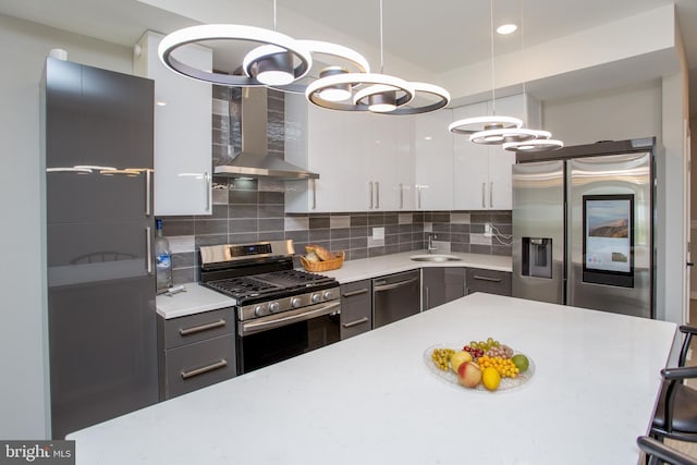 kitchen featuring appliances with stainless steel finishes, decorative backsplash, a sink, and light countertops