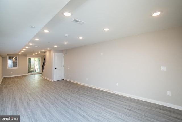 empty room featuring baseboards, wood finished floors, visible vents, and recessed lighting