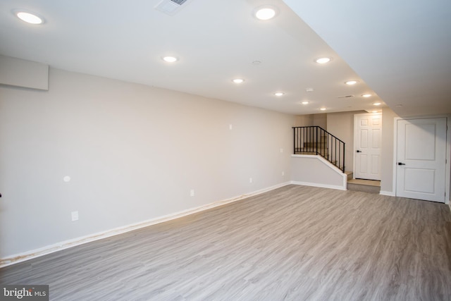 interior space with recessed lighting, visible vents, wood finished floors, baseboards, and stairs