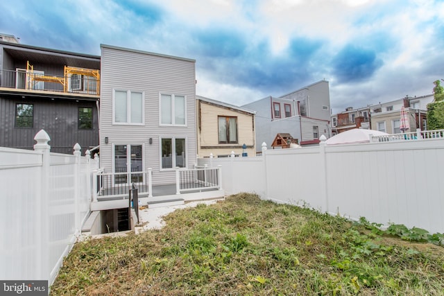 back of property featuring a fenced backyard