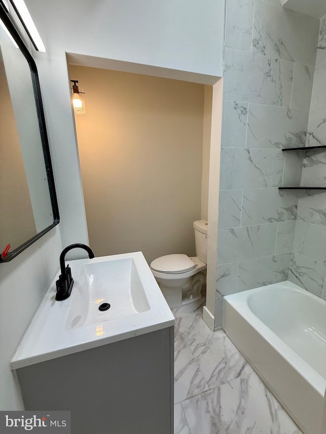 bathroom with toilet, marble finish floor, and vanity