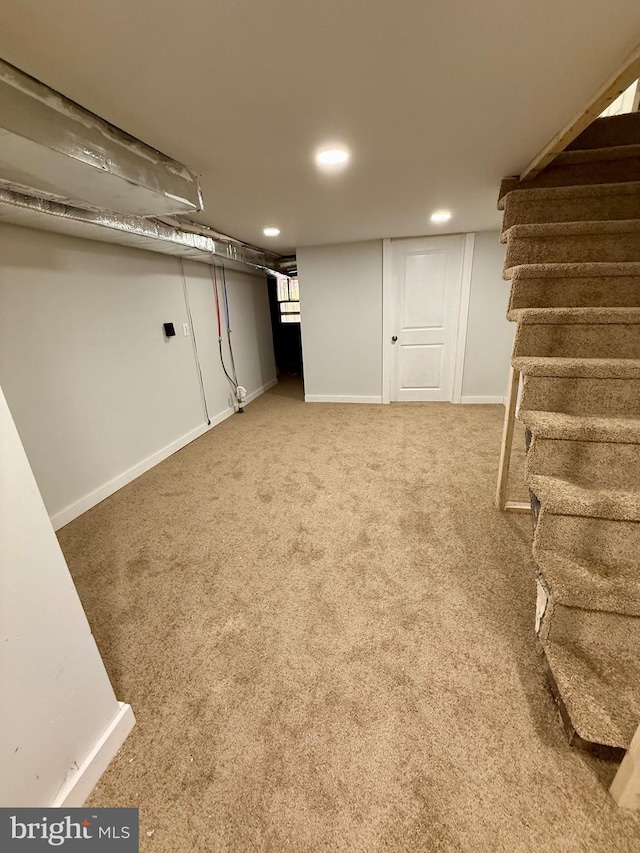 finished below grade area featuring carpet floors, stairs, baseboards, and recessed lighting