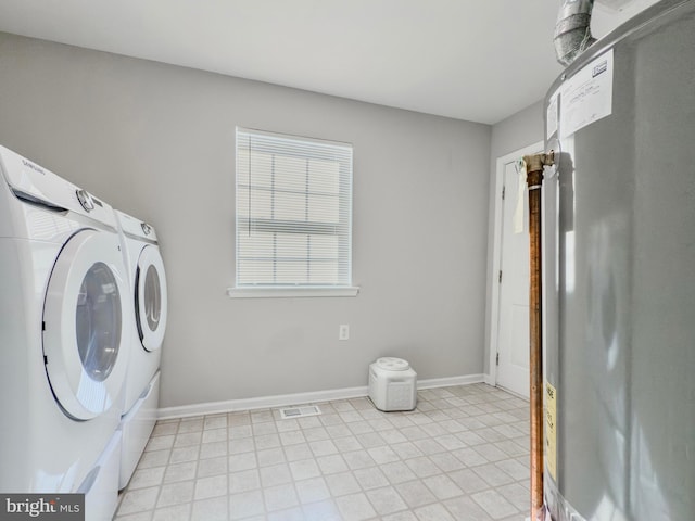 clothes washing area featuring laundry area, visible vents, washer and clothes dryer, and baseboards