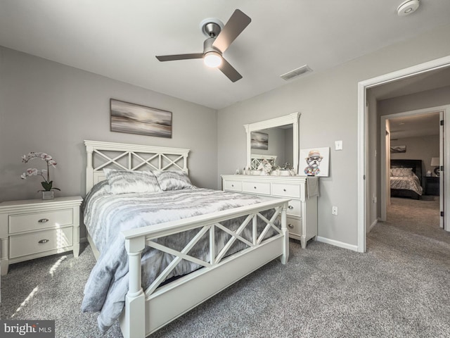 bedroom with a ceiling fan, carpet flooring, visible vents, and baseboards