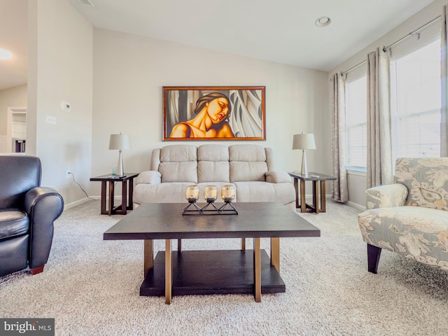 living area with carpet floors, lofted ceiling, and baseboards