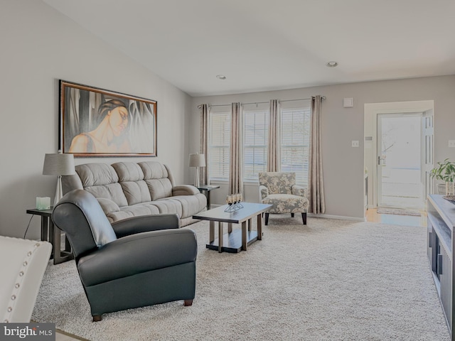 living area featuring carpet and baseboards