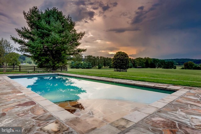 13401 Longnecker Rd, Reisterstown, MD 21136 - pool at dusk featuring an outdoor pool, a patio area, a yard, and fence