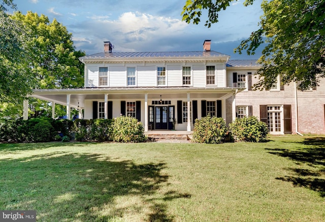 13401 Longnecker Rd, Reisterstown, MD 21136 - rear view of house with a standing seam roof, a chimney, and a lawn