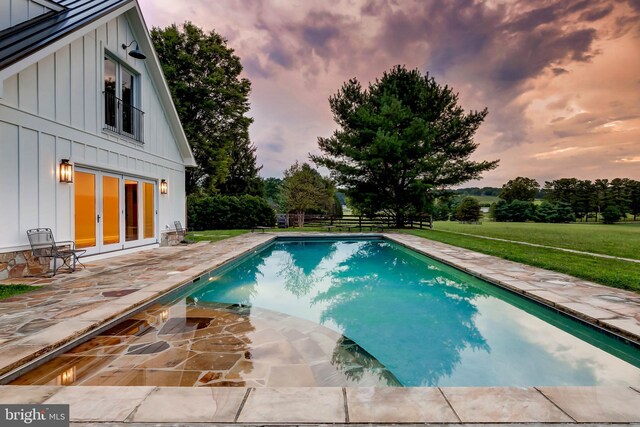 13401 Longnecker Rd, Reisterstown, MD 21136 - pool at dusk featuring a patio area, an outdoor pool, a lawn, and french doors