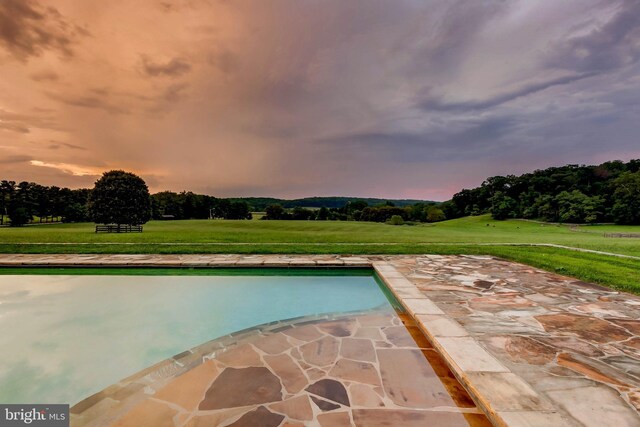 13401 Longnecker Rd, Reisterstown, MD 21136 - pool at dusk featuring a yard, a patio area, and an outdoor pool