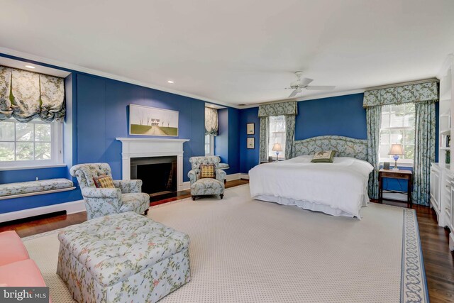 13401 Longnecker Rd, Reisterstown, MD 21136 - bedroom with a fireplace with raised hearth, multiple windows, wood finished floors, and crown molding
