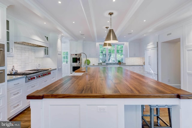 13401 Longnecker Rd, Reisterstown, MD 21136 - kitchen featuring white cabinets, appliances with stainless steel finishes, wooden counters, and beam ceiling