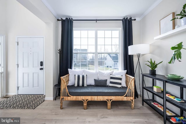 living area featuring baseboards and wood finished floors