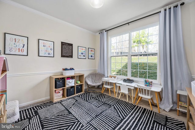 office area featuring a healthy amount of sunlight, baseboards, and ornamental molding