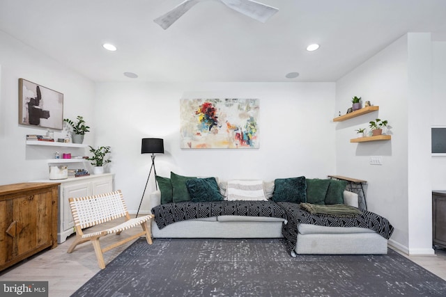 living room featuring recessed lighting, wood finished floors, and baseboards