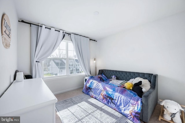 bedroom featuring carpet flooring and baseboards