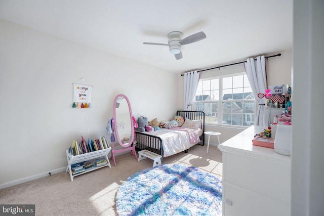 bedroom with ceiling fan, baseboards, and light carpet