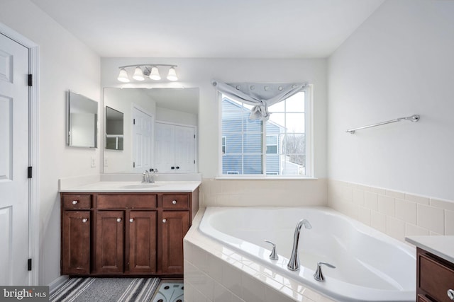 bathroom featuring vanity and a garden tub