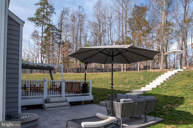 view of patio featuring a deck, fence, and a pergola