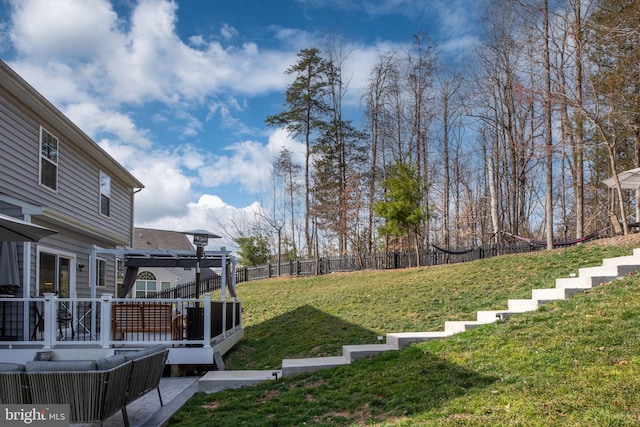 view of yard featuring a pergola, a deck, and fence