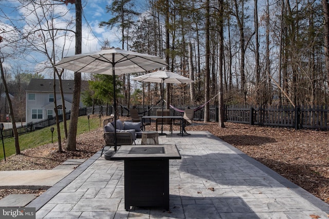 view of patio with outdoor dining space, outdoor lounge area, and a fenced backyard