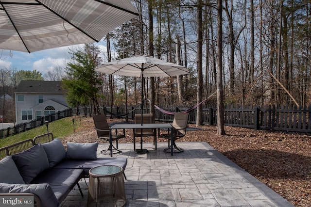 view of patio featuring an outdoor living space, outdoor dining area, and a fenced backyard