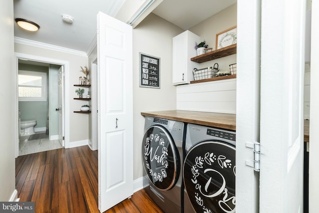 laundry room featuring laundry area, baseboards, dark wood-style floors, ornamental molding, and washer and dryer