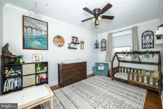 bedroom with ornamental molding, baseboards, and wood finished floors