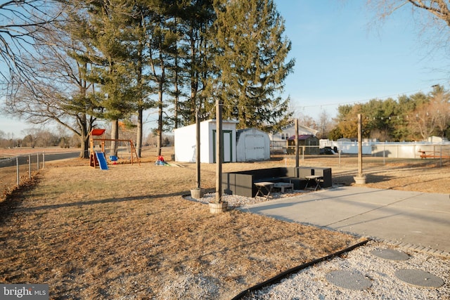 exterior space with a shed, fence, playground community, and an outdoor structure