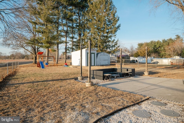 exterior space featuring a shed, fence, playground community, and an outdoor structure