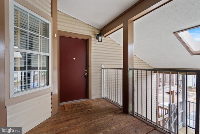 view of exterior entry featuring a balcony