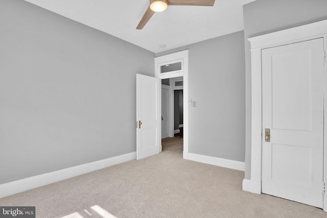 unfurnished bedroom featuring a closet, carpet flooring, ceiling fan, and baseboards